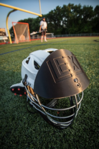 Lacrosse shield to protect head against ball impact.